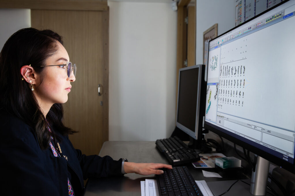 Science marketer looking at a screen, selecting images for content
