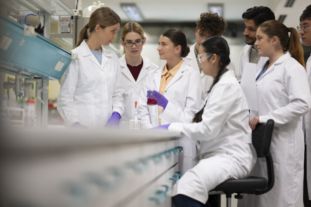 Scientists discussing as a group in the laboratory